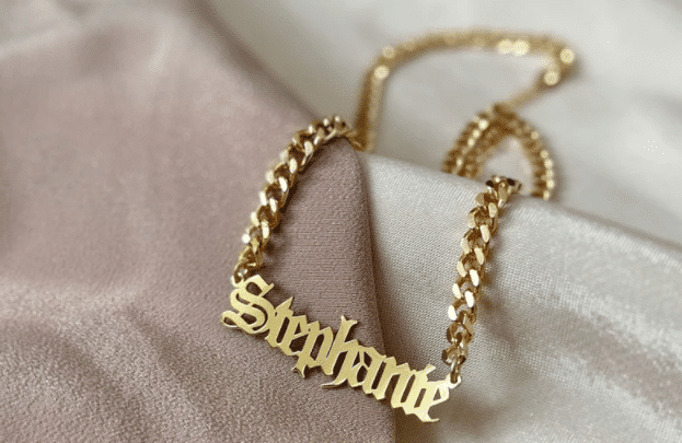 A gold chain with name tag on it Description automatically generated