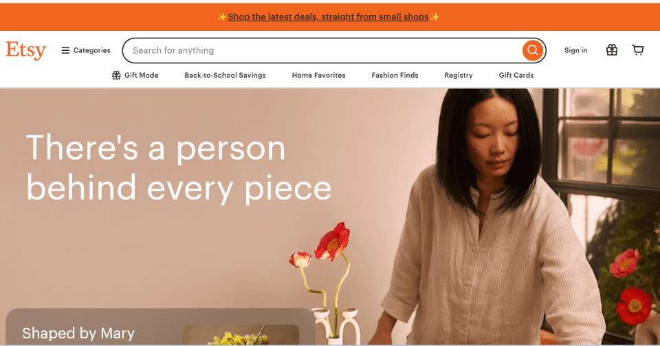 A person standing next to a table with flowers Description automatically generated