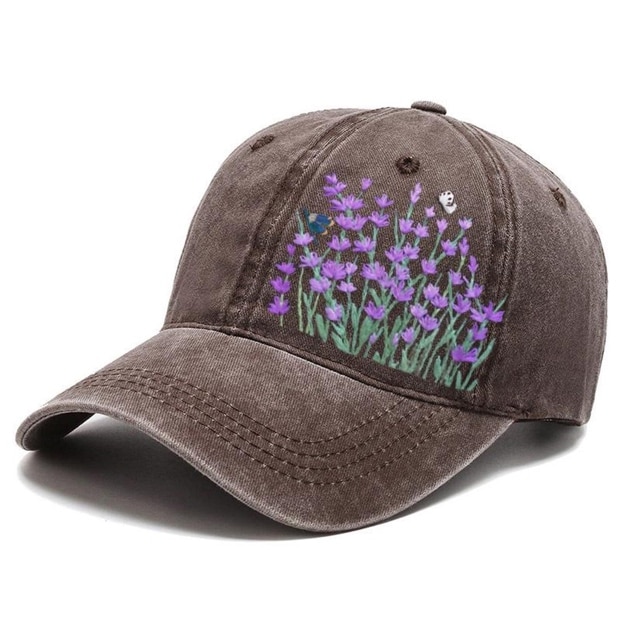 May include: A brown baseball cap with an embroidered design of purple flowers and green leaves.