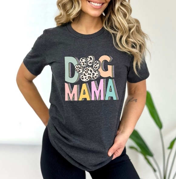 May include: A gray t-shirt with the text 'Dog Mama' in colorful letters with a paw print in the center of the text. The paw print is in a leopard print pattern.