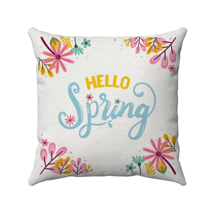 May include: A white pillow with a floral design and the text 'HELLO Spring' in blue script. The flowers are pink, yellow, and green.