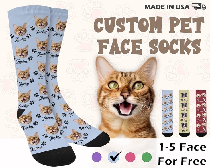 May include: Custom pet face socks, made in the USA. Light blue crew socks feature a repeating pattern of paw prints and cat faces. The cat faces are personalized with the name 'Lucky.' Additional sock options are shown with various pet faces and text options, including 'Your Text.' 1-5 faces can be added for free. Color options are shown.