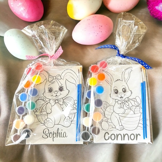 May include: Two Easter bunny paint and sip kits with paintbrushes and paint pots. The canvas on the left has the name Sophia and the canvas on the right has the name Connor.