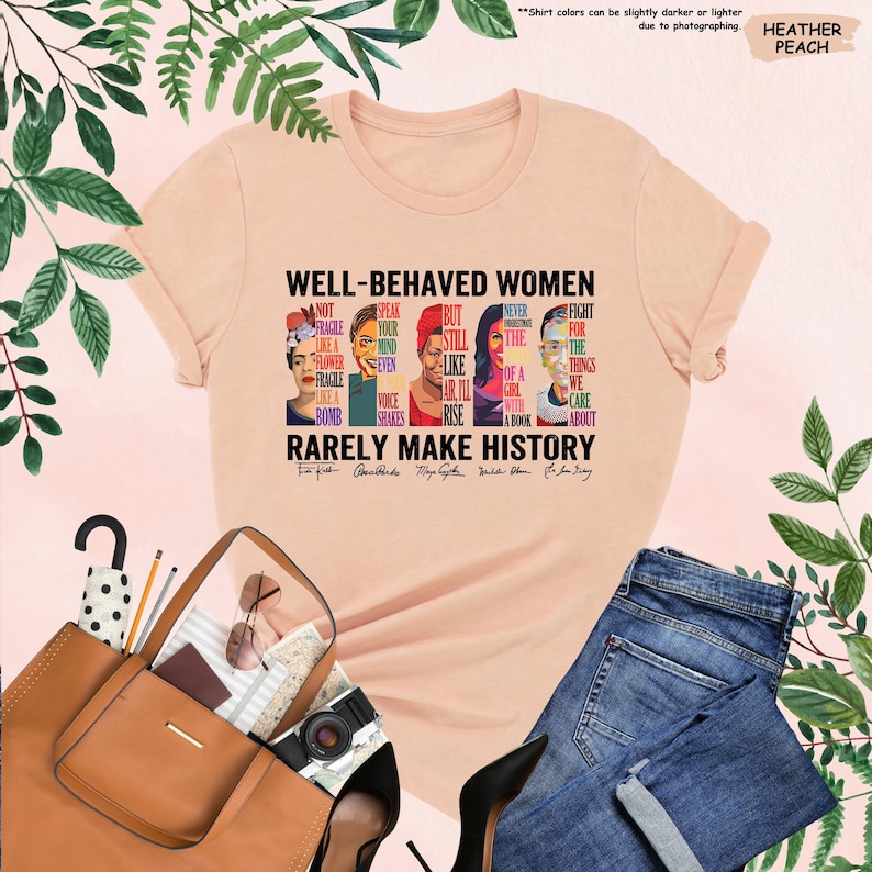 May include: A peach colored t-shirt with a graphic print of famous women and the text "Well-behaved women rarely make history". The graphic features portraits of Frida Kahlo, Audre Lorde, Maya Angelou, Michelle Obama, and Ruth Bader Ginsburg.
