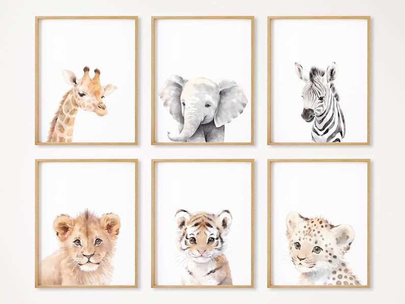 May include: Set of six watercolor animal prints featuring a giraffe, elephant, zebra, lion, tiger, and leopard. Each print is framed in a light wood frame and has a white background.