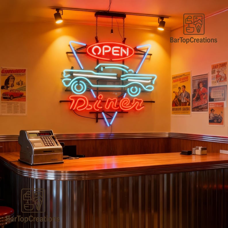May include: A neon sign for a diner, featuring a classic car silhouette in blue and the word "Diner" in red. The sign also includes the word "OPEN" and is mounted on a wall with vintage posters and a wooden counter.